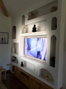 a living room with a flat screen tv on a wall at Villa between forest and ocean in Labenne