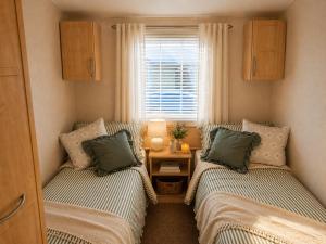 a small room with two beds and a window at High View in Freystrop