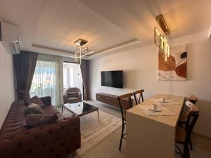 a living room with a couch and a table at Mykonos Homes Cyprus in Kyrenia