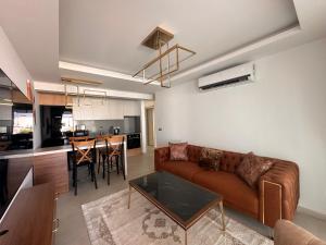 a living room with a couch and a table at Mykonos Homes Cyprus in Kyrenia