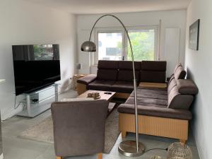 a living room with two couches and a flat screen tv at Wohnung in ruhiger Wohnlage in Bad Kreuznach