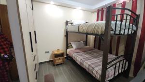 a room with two bunk beds and a small bed at Blooming Sanctuary in Ruiru