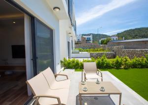 a patio with two chairs and a table on a balcony at Aqualina D5-1 by HolidayKeys in Kyrenia