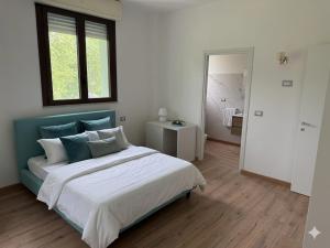 a bedroom with a large bed and a window at Hotel Venus in Milano Marittima