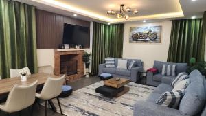 a living room with a couch and a table at Blooming Sanctuary in Ruiru
