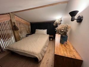 a bedroom with a bed and a vase of flowers at Villa between forest and ocean in Labenne +37 photos
