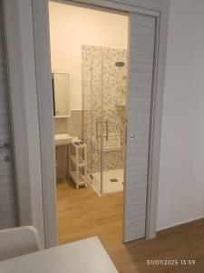 a bathroom with a glass door and a sink at dante 55 in Agrigento +16 photos