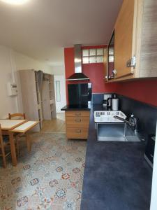 a kitchen with a stove and a table in it at Studio au coeur pays basque in Ustaritz