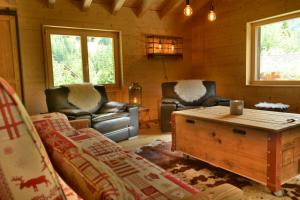 a living room with couches and a coffee table at Chalet Rustifol in Orsières