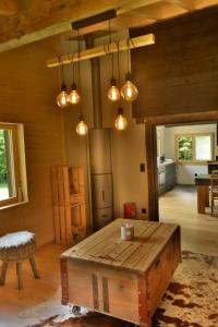 a living room with a wooden table and lights at Chalet Rustifol in Orsières +36 photos