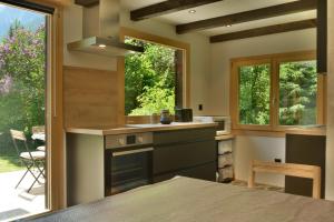 a kitchen with a stove top oven next to a window at Chalet Rustifol in Orsières