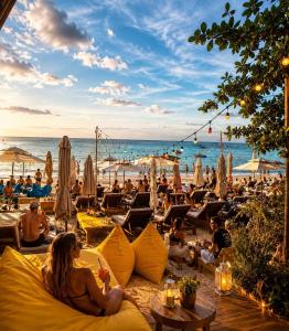 a group of people sitting on the beach at Moonrise Beachfront Luxury in Nathon Bay
