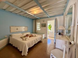 a bedroom with a bed and a large window at Albergo isola mia in Favignana