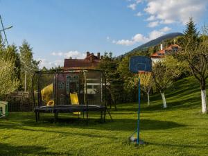 a playground with a play set in the grass at Cazare Colibita - Casa Lipan cu jacuzzi, foișor și loc de joacă in Colibiţa