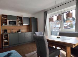 a kitchen and dining room with a table and chairs at Sonnenbichl in Berwang +19 photos