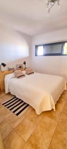 a large white bedroom with a large white bed at Jardín del Teide in Puerto de la Cruz +26 photos