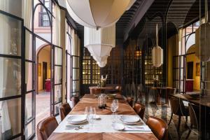 a dining room with a long table and chairs at Riad Dar Al Dall - This Time Tomorrow in Marrakech in Marrakesh