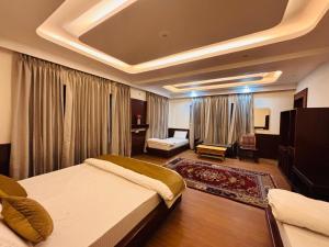 a hotel room with a bed and a living room at Teyser Holiday Home in Leh