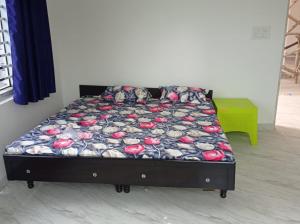 ein Bett in einem Zimmer mit einem Bett, auf dem Schuhe stehen in der Unterkunft Rana Complex in Nādaun
