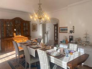 a dining room with a table with chairs and a chandelier at Bed & Breakfast Lujocanda in Casarza Ligure