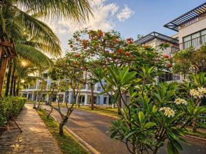 a street with palm trees and a street with buildings at Bareka Hotel in Phú Quốc