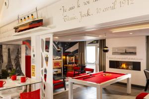 a billiard room with a red pool table at Hôtel Gustave Colmar in Colmar