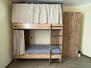 a bunk bed in a room with a window at ATB Grand Hostel in Atyrau