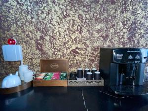 a coffee station with a coffee maker and a coffeemaker at ATB Grand Hostel in Atyrau