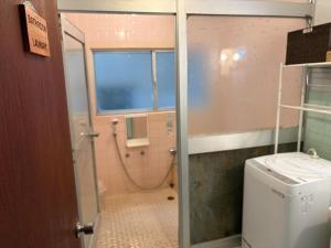 a bathroom with a washing machine and a washer and dryer at 麻心家azamiya in Nagao +43 photos