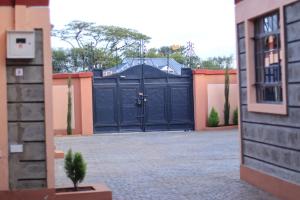 a large garage with a blue garage door at BomaZuri Homestays Tala in Nguluni