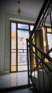a view of a room with a window and a staircase at The Garden of Shaherezade in Bukhara