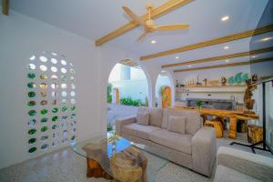 a living room with a couch and a table at Serenity Garden Villas by Danka Hospitality in Hang Nadim International Airport