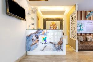 a ticket booth in a room with a couch at Treebo Ivy Castle in Gurgaon