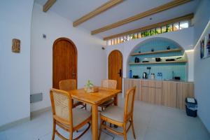 a dining room with a wooden table and chairs at Serenity Garden Villas by Danka Hospitality in Hang Nadim International Airport +18 photos