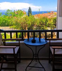 a table on a balcony with a view of the ocean at Villa Galani Afitos in Afitos