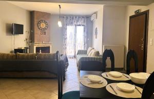 a living room with a couch and a table at Villa Galani Afitos in Afitos