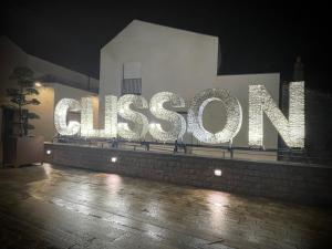 a large sign that says cissont on a building at night at Au petit Chapeau Rouge in Clisson