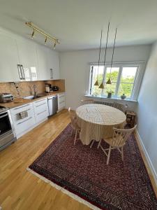 a kitchen with a table and chairs in a room at Fantastic accommodation in central Kalmar in Kalmar