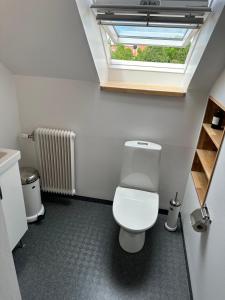 a bathroom with a white toilet and a window at Fantastic accommodation in central Kalmar in Kalmar