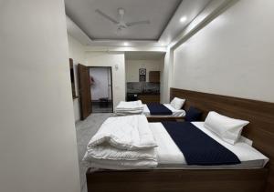 two twin beds in a room with at Sky Homestay in Noida