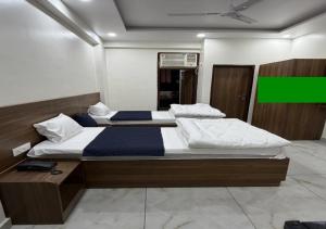 a large bed in a room with a green at Sky Homestay in Noida