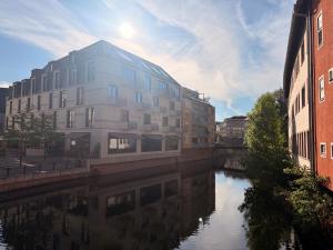 a building on the side of a river with buildings at Burghotel - Das Original in Nuremberg