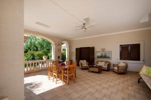 a living room with a table and chairs at Villa Tonia in Fasano