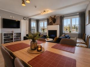a living room with a dining table and a living room with a fireplace at Golsfjellet Apartment with Sauna in Gol