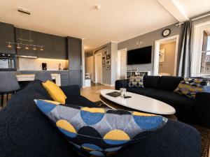 a living room with a couch and a table at Golsfjellet Apartment with Sauna in Gol