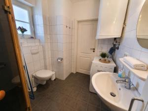 a white bathroom with a toilet and a sink at Golsfjellet Apartment with Sauna in Gol +12 photos