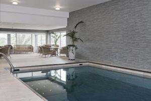 a house with a swimming pool in a living room at Scandic Norrköping Nord in Norrköping
