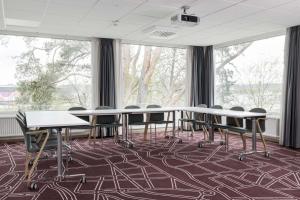 a conference room with tables and chairs and windows at Scandic Norrköping Nord in Norrköping +31 photos