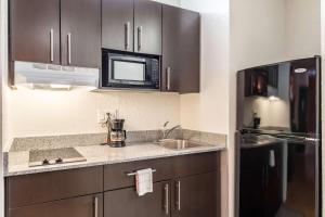 a kitchen with a sink and a microwave at Motel 6-Uvalde, TX in Uvalde