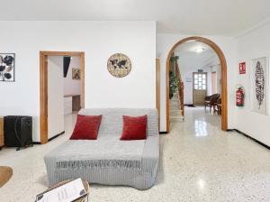 a bedroom with a bed with red pillows on it at Casa Maruca with Roque Nublo view in Tejeda